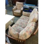An Ercol three seater sofa with armchair and footstool