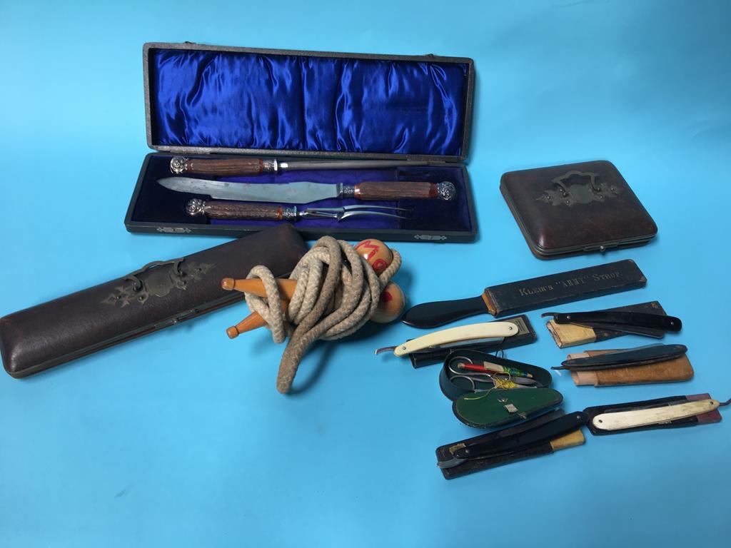 A tray of assorted, to include a carving set, razors and a strop etc.