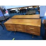 A teak chest of drawers and dressing table