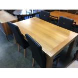 A modern oak dining table and four chairs