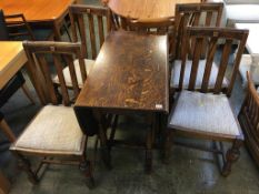 An oak gateleg dining table and four chairs