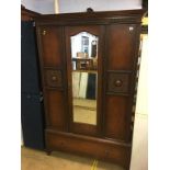 An oak mirror door wardrobe