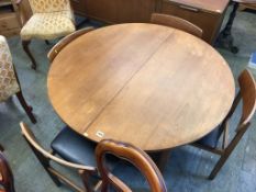 A teak extending dining table and four chairs