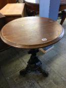 A circular pub table on cast base