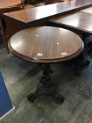 A circular pub table on cast base