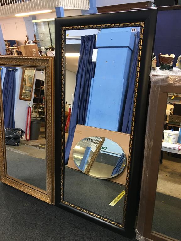 A black and gilt framed mirror