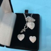 A silver necklace and matching earrings