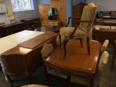 A walnut eight piece dining room suite, comprising extendable table, six chairs (4+2) and a