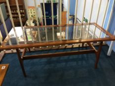 A teak and glass coffee table