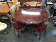 A circular Italian style dining table and four chairs