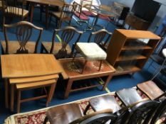 A teak coffee table, bookcase and nest of tables e