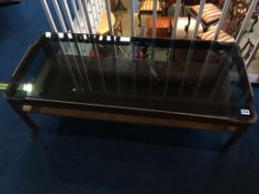 A teak and glass coffee table