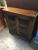 An oak glazed bookcase