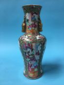 A Chinese Canton enamelled vase, with two gilt stags head handles, decorated with panels of