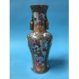 A Chinese Canton enamelled vase, with two gilt stags head handles, decorated with panels of