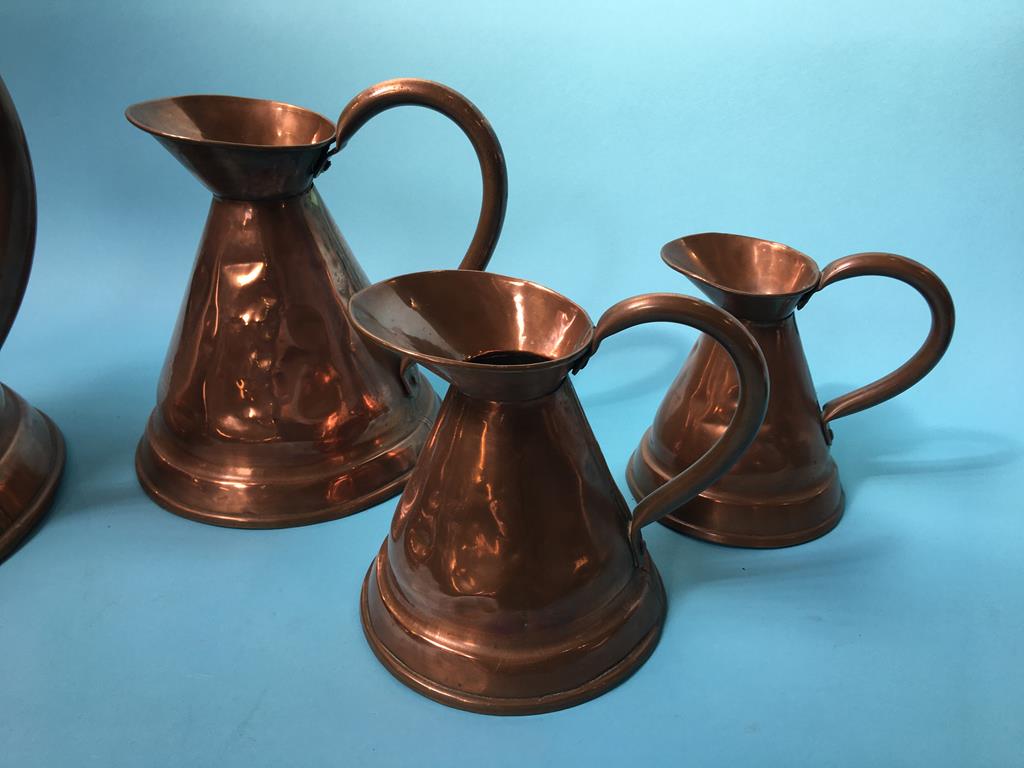 Four graduated copper jugs - Image 2 of 2