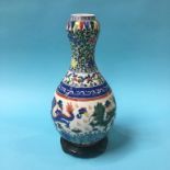 A Chinese porcelain vase with waisted neck and baluster shape body, decorated with dragons, 34cm