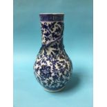 A Chinese blue and white vase, with waisted neck and baluster body, decorated with dragons, 35cm