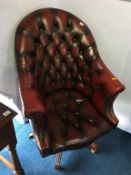 An oxblood leather Chesterfield swivel tub armchair