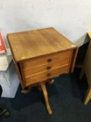 A drop flap table, with three single drawers