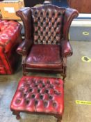 A leather oxblood wingback Chesterfield, armchair and matching footstool