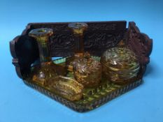 A carved bookrest and a glass dressing table set