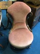 A Victorian walnut nursing chair, with pink upholstery