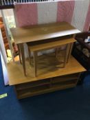 An oak TV base unit and two occasional tables