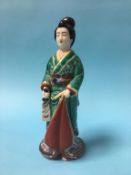 An Oriental porcelain figure of a lady, 28cm high