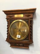 A wall mounted oak and barley twist barometer