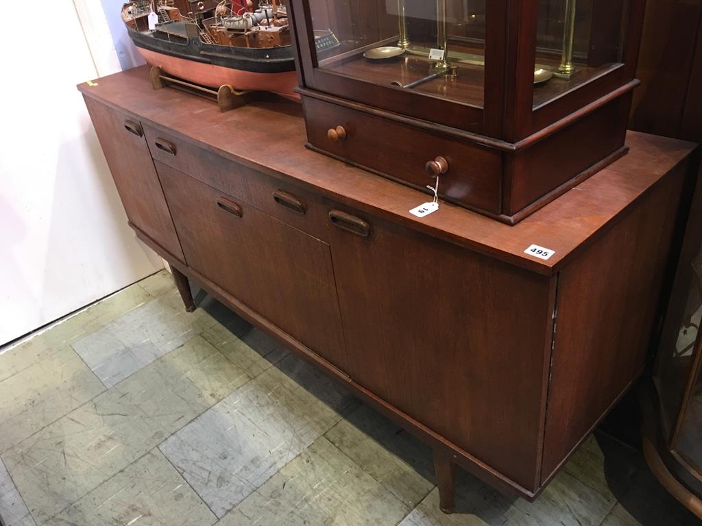 A neat teak sideboard, 153cm long, 46cm diameter and 74cm high