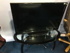 A Hitachi 42" TV and oval glass table
