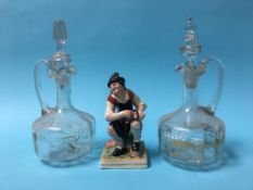 A pair of decanters and a Staffordshire figure of a cobbler