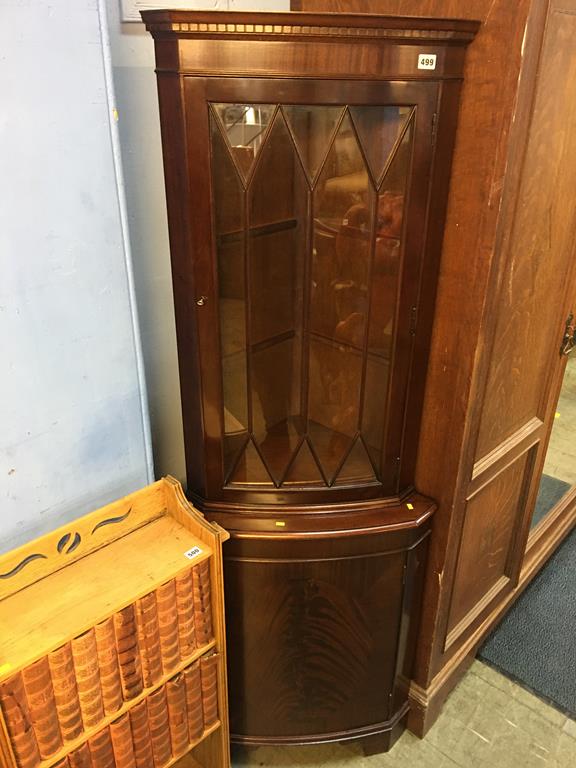 A reproduction mahogany corner cabinet