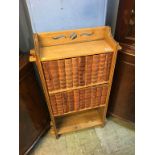 A small oak bookcase, with a collection of books