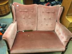 An Edwardian pink upholstered two seatter settee.