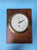 An Octo 'Mercer' brass ships clock, mounted on an oak panel