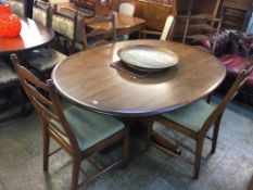 An Ercol oval dining table and four ladderback chairs