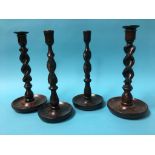 Two pairs of oak barley twist candlesticks