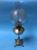 A brass oil lamp, with etched glass shade