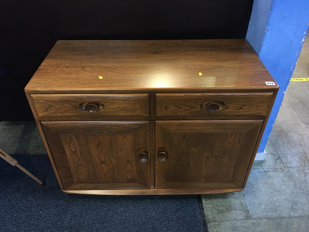 A small two door Ercol sideboard, 91cm length, 69cm high, 44cm diameter