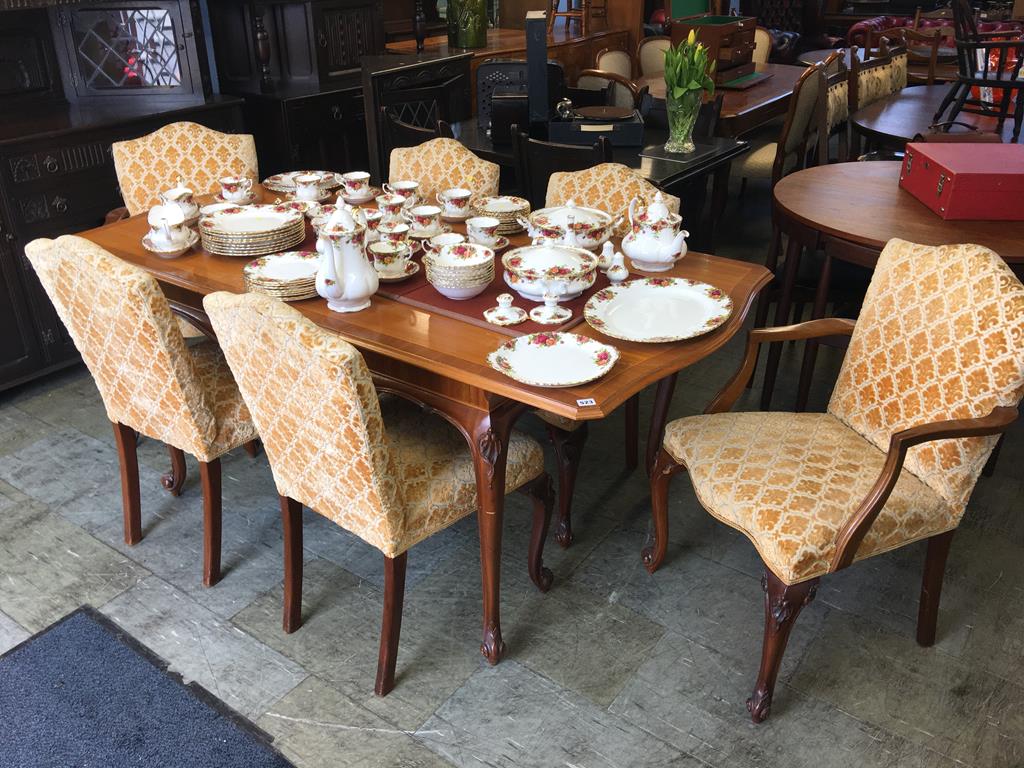 A walnut extending dining table and six (4+2) chairs