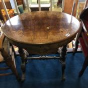 A Victorian walnut oval and marquetry inlaid sewing table with fitted interior, supported on