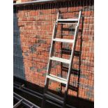 A set of extending ladders 11ft in height etc.