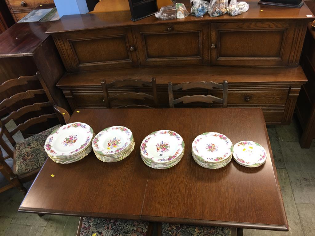 An oak dining room suite comprising sideboard, table and five chairs