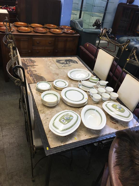 A marble inset dining table with four metal work chairs