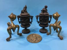 A pair of Victorian metalware two handled vases and covers, 35cm height and a pair of brass fire