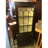 A mahogany standing corner cabinet