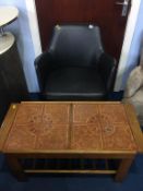 A swivel office chair and a teak tile top coffee table.