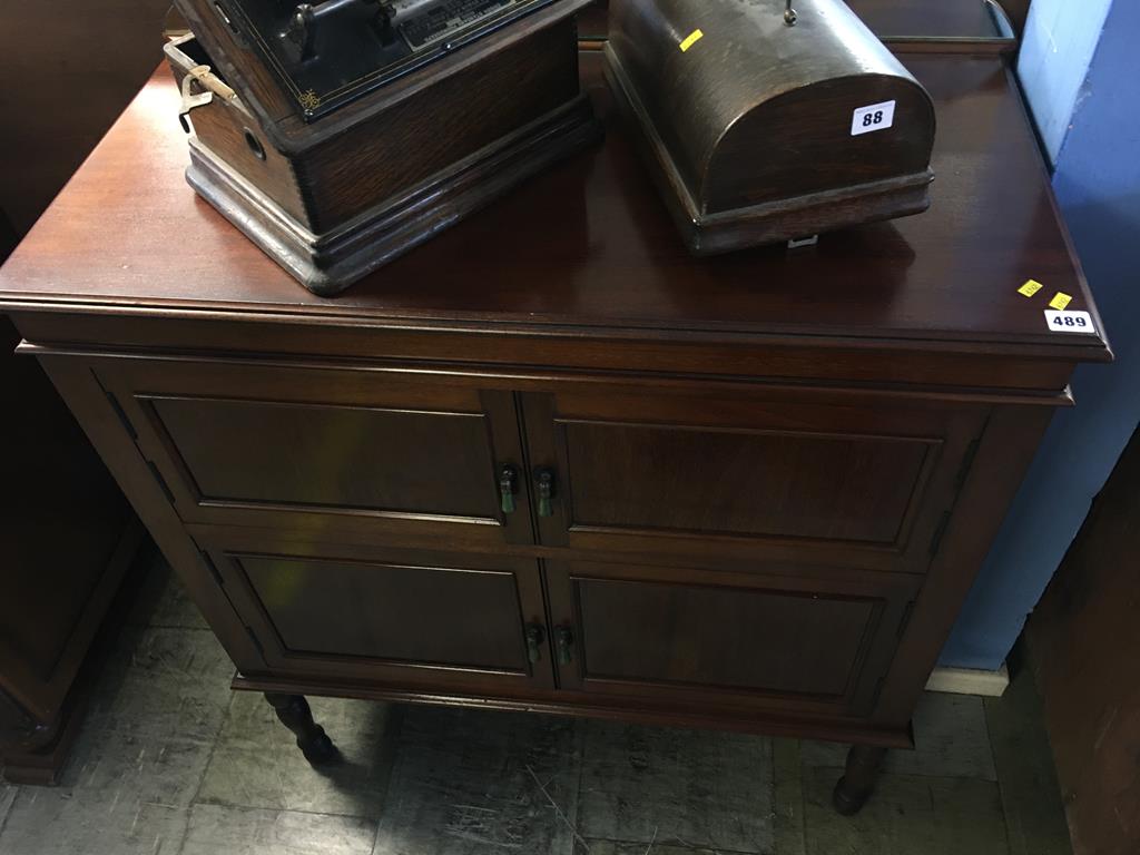 A small mahogany mirror back cabinet